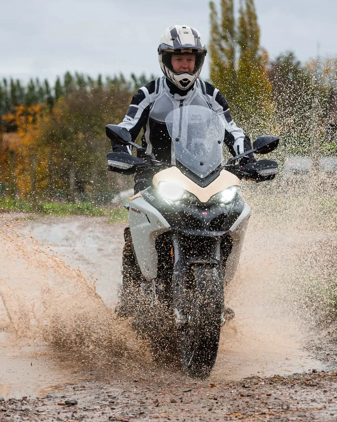 Rider pe motocicletă, într-un cadru outdoor ud, cu accent pe control și stabilitate pe ploaie